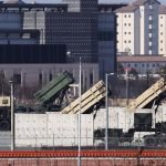MIM-104 Patriot missile defence launchers deployed on a rooftop in an urban military zone