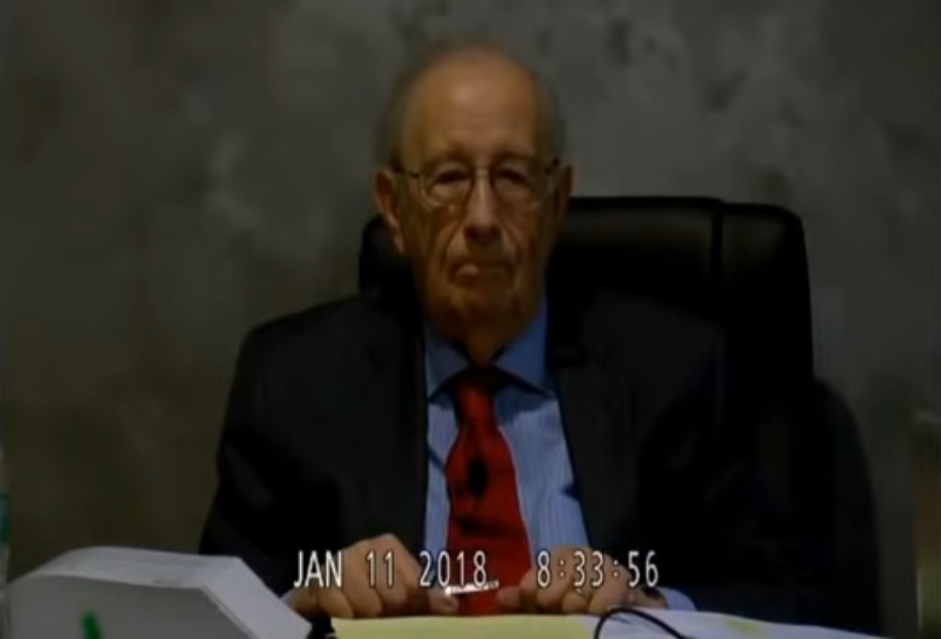 Dr. Stanley Plotkin seated during a videotaped legal deposition on January 11, 2018