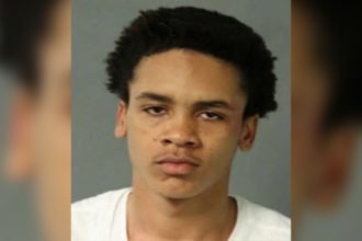 Police booking mugshot photo of homicide suspect Naseem Sills against a gray background.