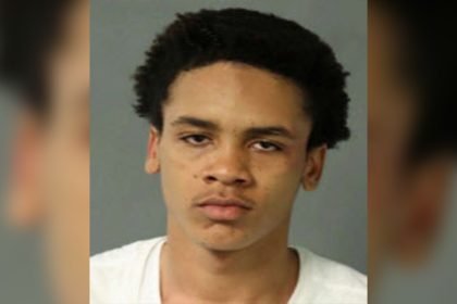 Police booking mugshot photo of homicide suspect Naseem Sills against a gray background.