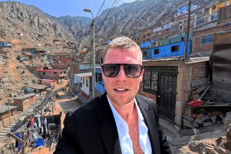 Panoramic view overlooking brick homes and informal settlements built on the rocky slopes of San Juan de Lurigancho in Lima, Peru.