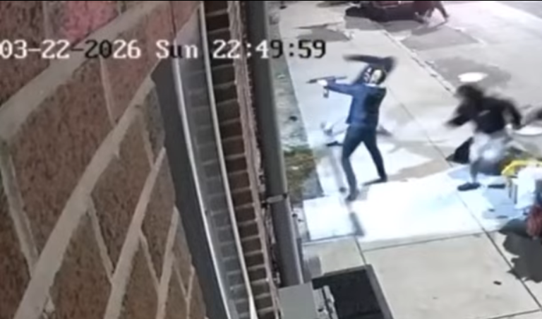 Surveillance camera footage timestamped March 22, 2026, showing suspect aiming a firearm on the sidewalk during a shooting incident on North 22nd Street in Philadelphia's 22nd Police District.